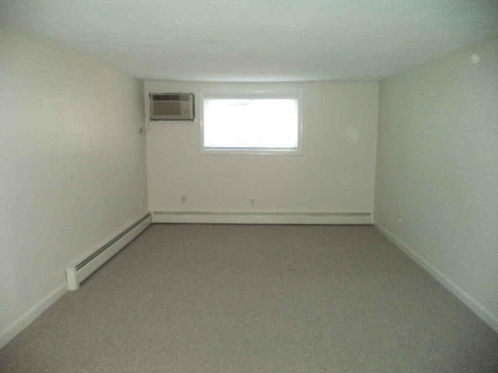 3 Pembroke Drive, Unit 5 Derry, NH 03038 - Photo 3 of 15 an empty room with a window