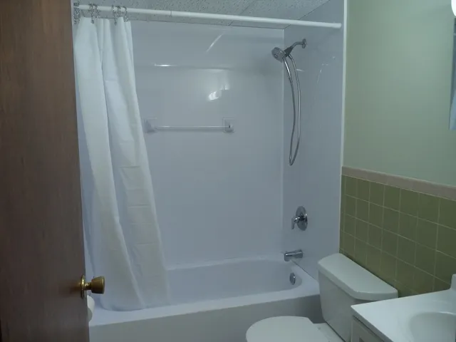 a bathroom with a bathtub and a shower