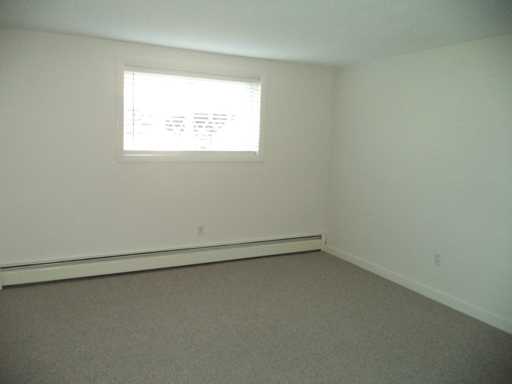 3 Pembroke Drive, Unit 5 Derry, NH 03038 - Photo 6 of 15 an empty room with a window