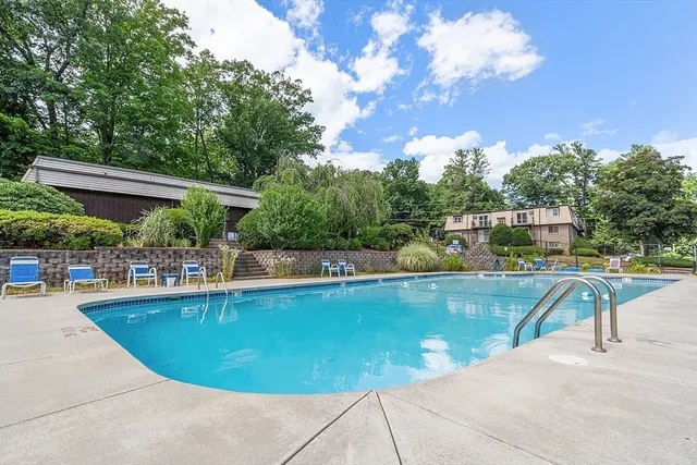 a view of a swimming pool with chairs