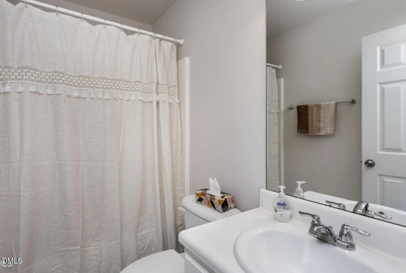 7031 Racine Way Raleigh, NC 27615 - Photo 23 of 24 a bathroom with a sink and a mirror