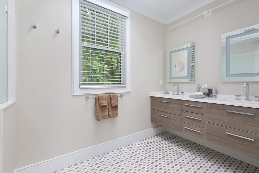 10 Doris Circle Newton, MA 02458 - Photo 13 of 21 a bathroom with a sink a mirror and a shower