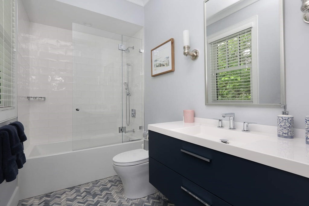 10 Doris Circle Newton, MA 02458 - Photo 15 of 21 a bathroom with a sink a toilet a tub and a window