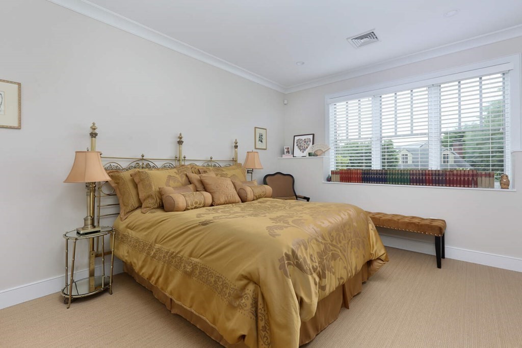 10 Doris Circle Newton, MA 02458 - Photo 16 of 21 a spacious bedroom with a bed and a large window