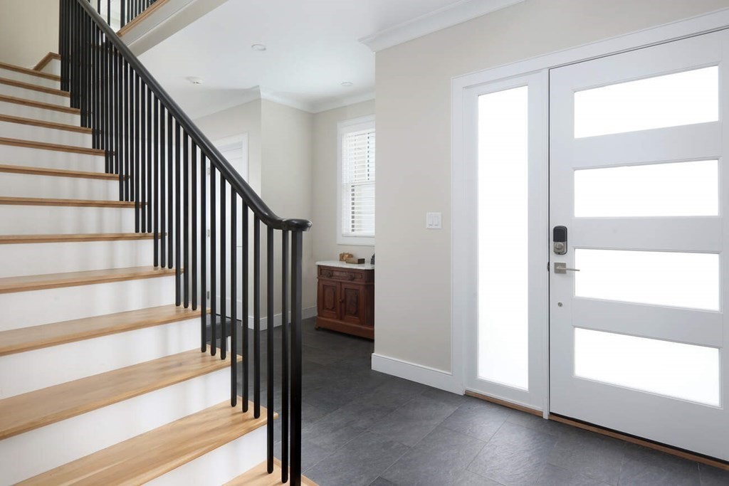 10 Doris Circle Newton, MA 02458 - Photo 3 of 21 a view of a hallway with wooden floor and windows