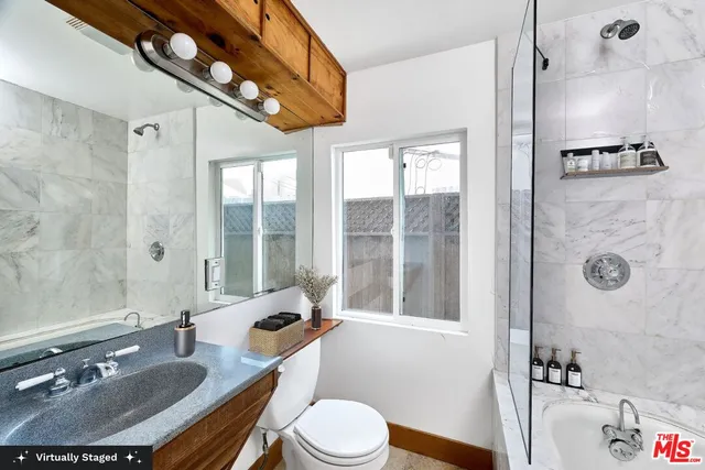 a bedroom with furniture and a window