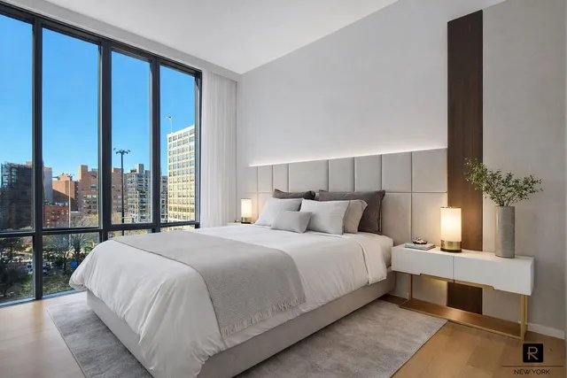 a bedroom with a large bed and a large window