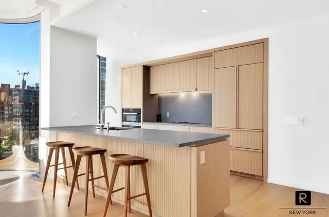 a bedroom with a large bed and a large window