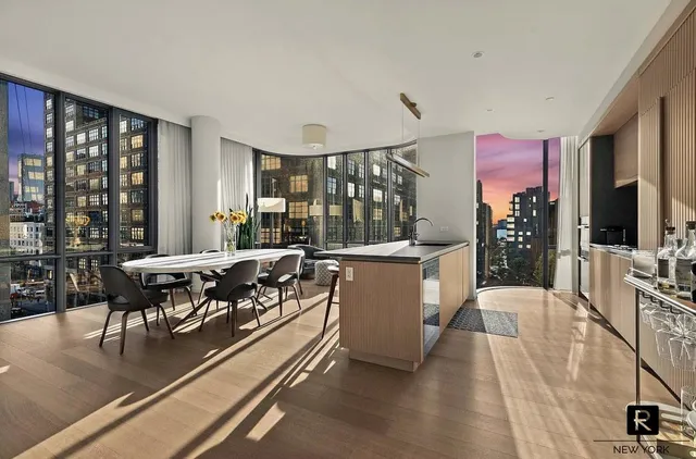 a living room with furniture potted plant and a table