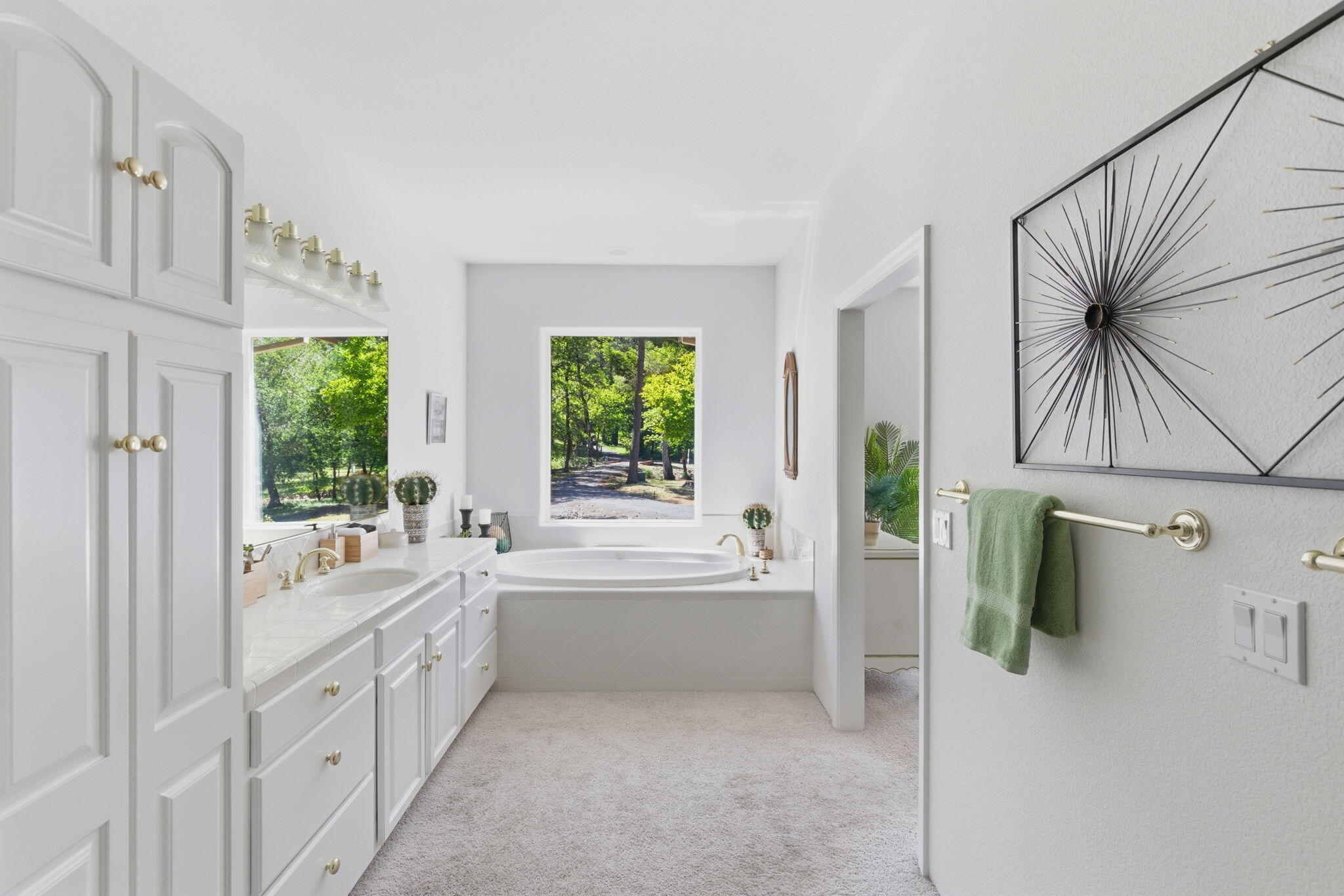 45 Marble Mountain Road Grants Pass, OR 97527 - Photo 13 of 40 Huge primary bathroom with a jacussi tub, cabinets for all your storage needs, linen closet and huge tiled walk in shower with two shower heads.
