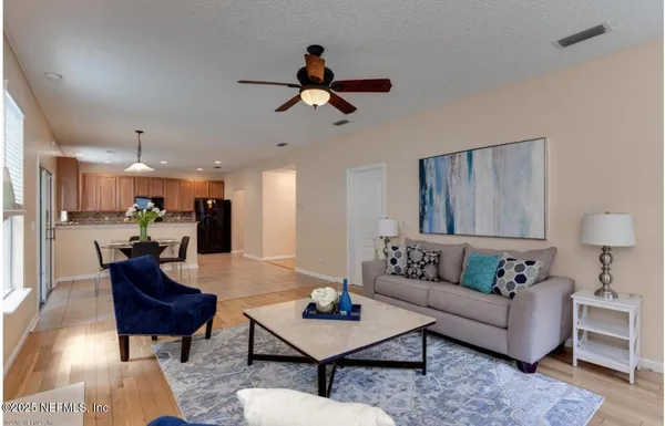 a living room with furniture and kitchen view
