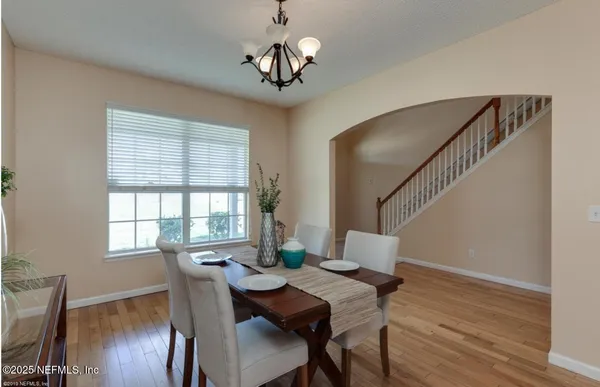 a view of a dining room with furniture window and wooden floor