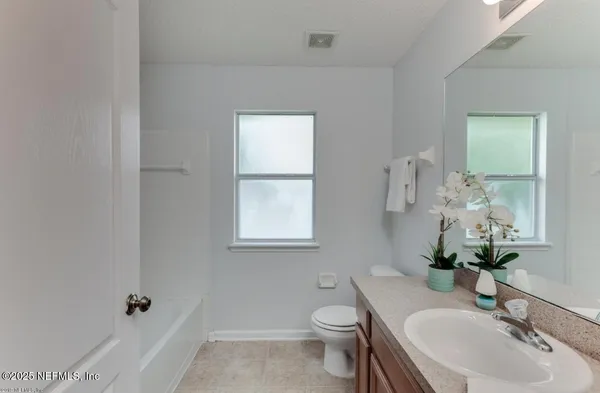 a bathroom with a sink toilet and tub
