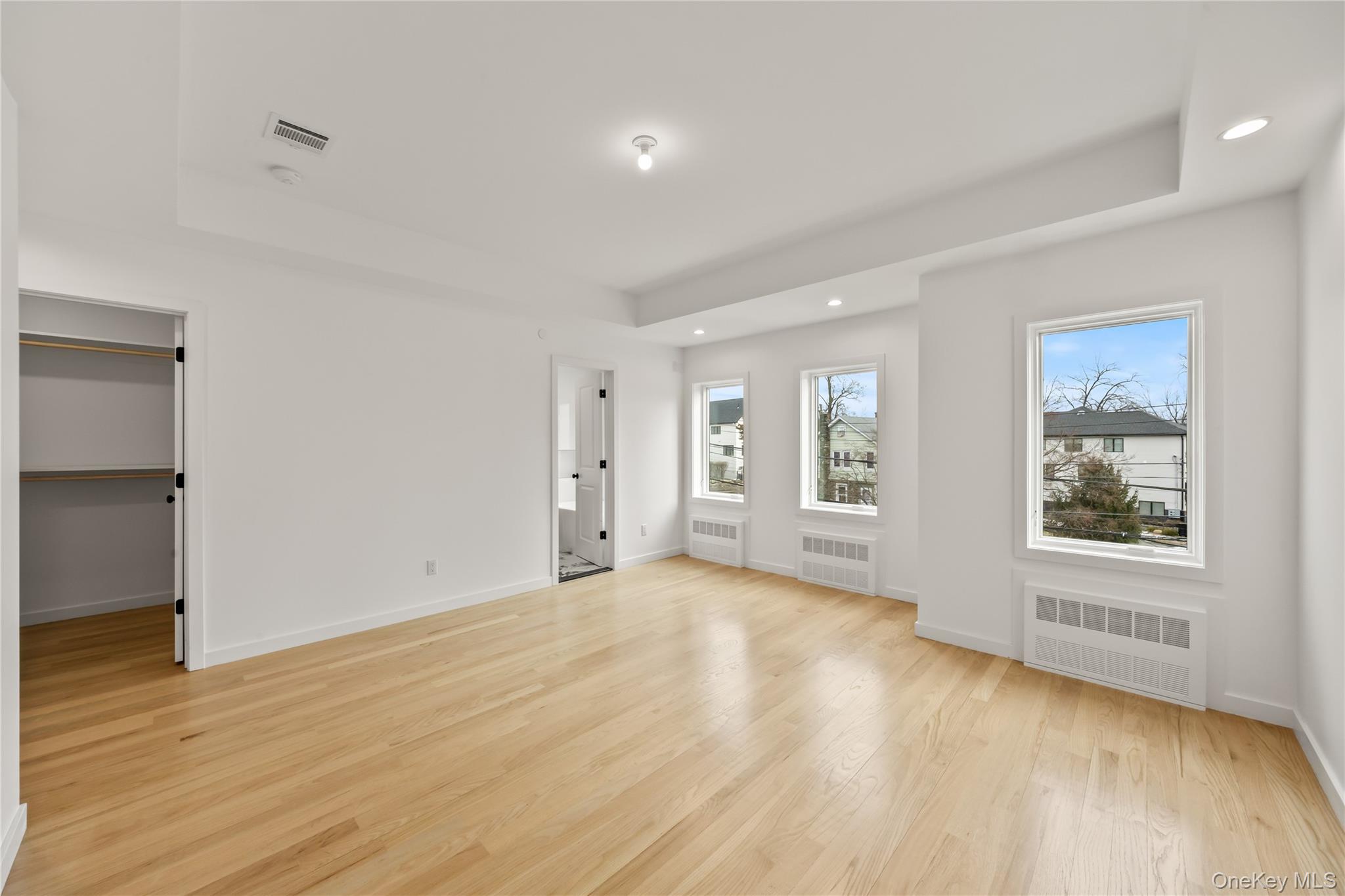 23 Singer Avenue, Unit 211 Spring Valley, NY 10977 - Photo 26 of 45 an empty room with wooden floor and windows
