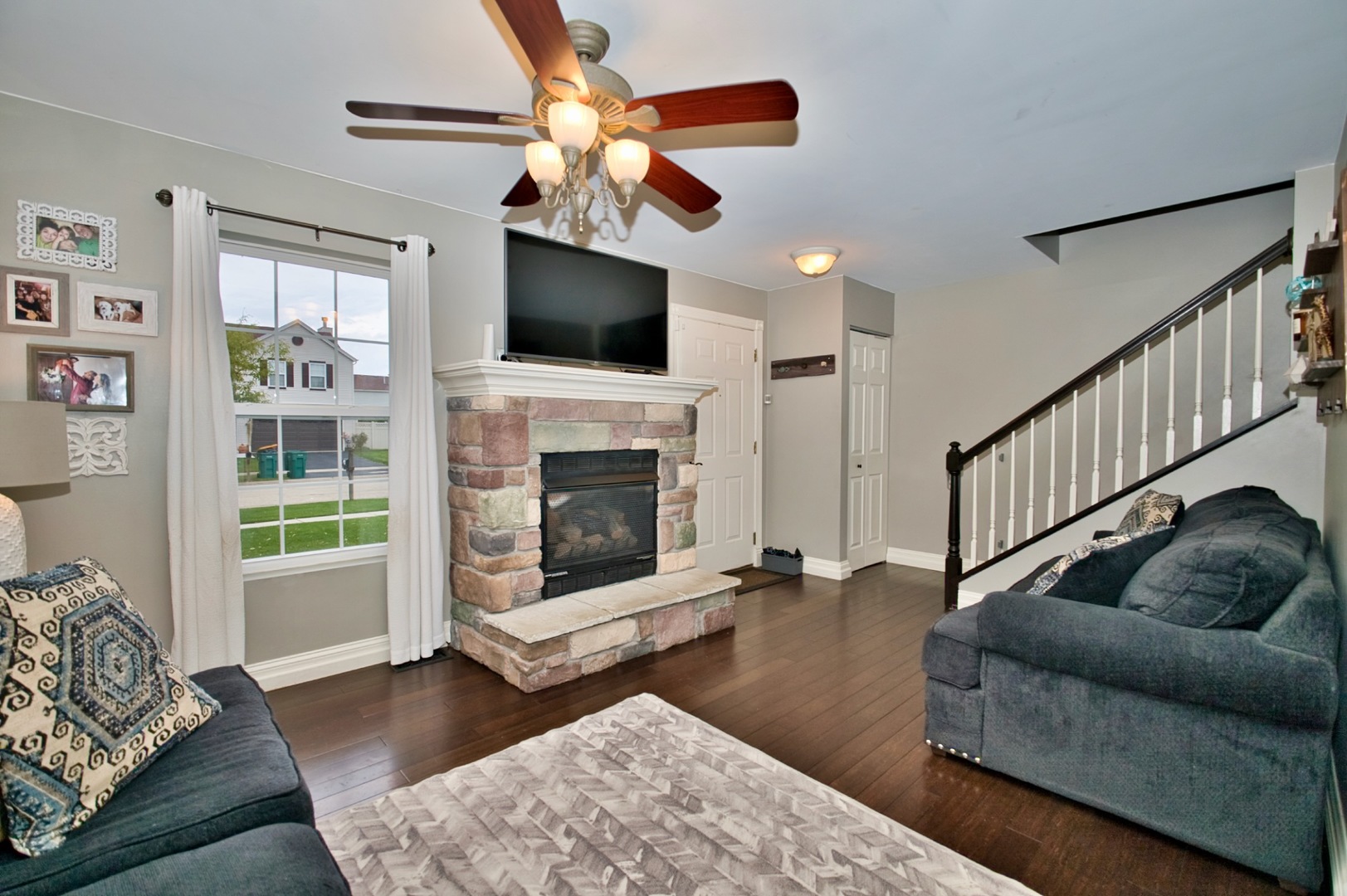 6313 Colton Ridge Court Plainfield, IL 60586 - Photo 4 of 57 a living room with furniture a flat screen tv and a fireplace