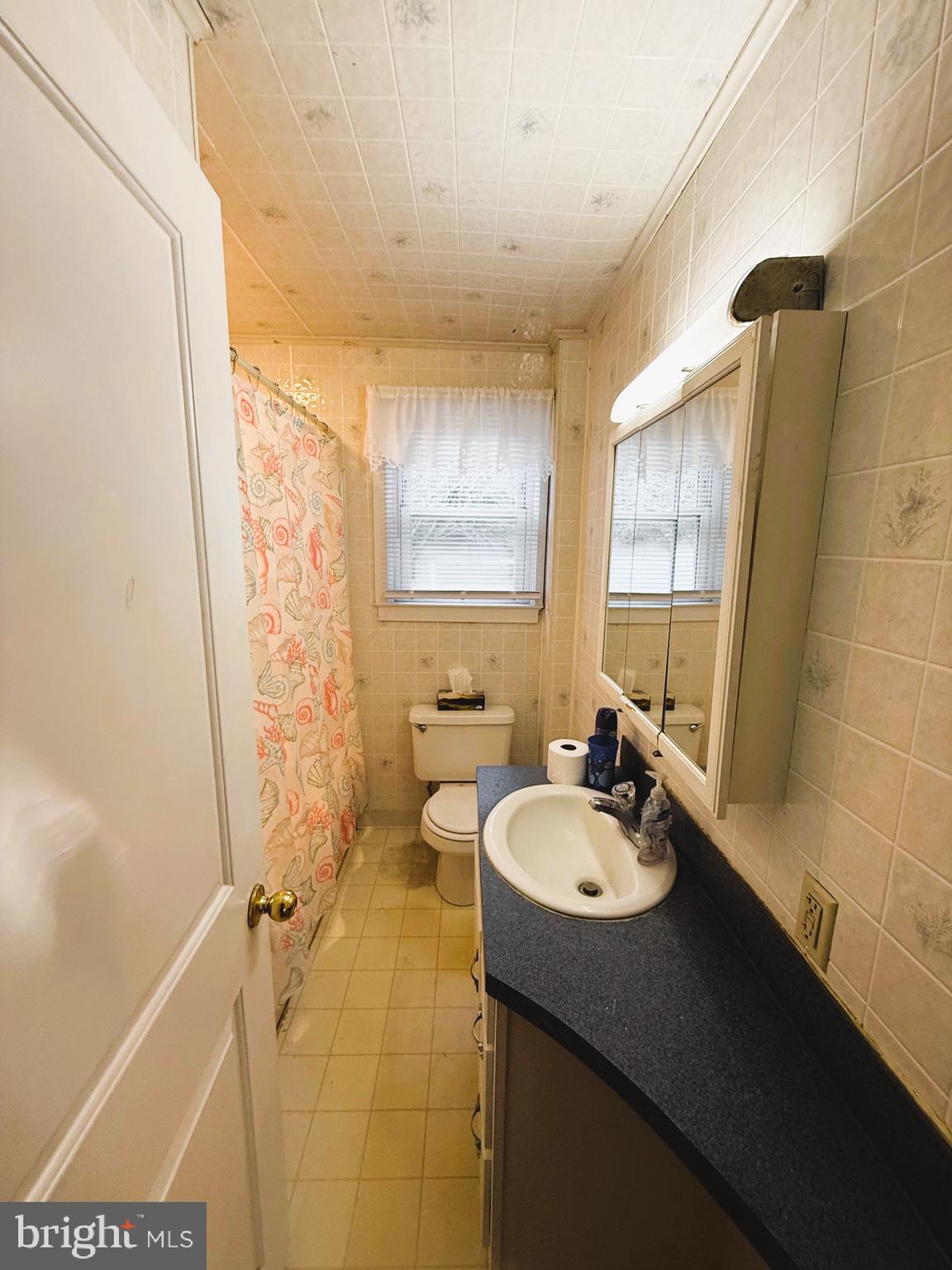 18 Cornell Avenue Bridgeton, NJ 08302 - Photo 12 of 20 a bathroom with a sink a mirror and a shower