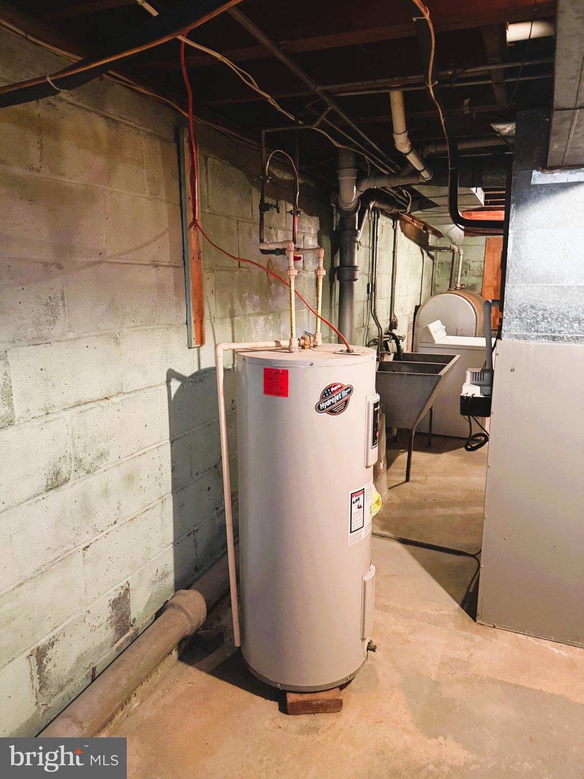 18 Cornell Avenue Bridgeton, NJ 08302 - Photo 19 of 20 a view of a storage room with water heater and racks