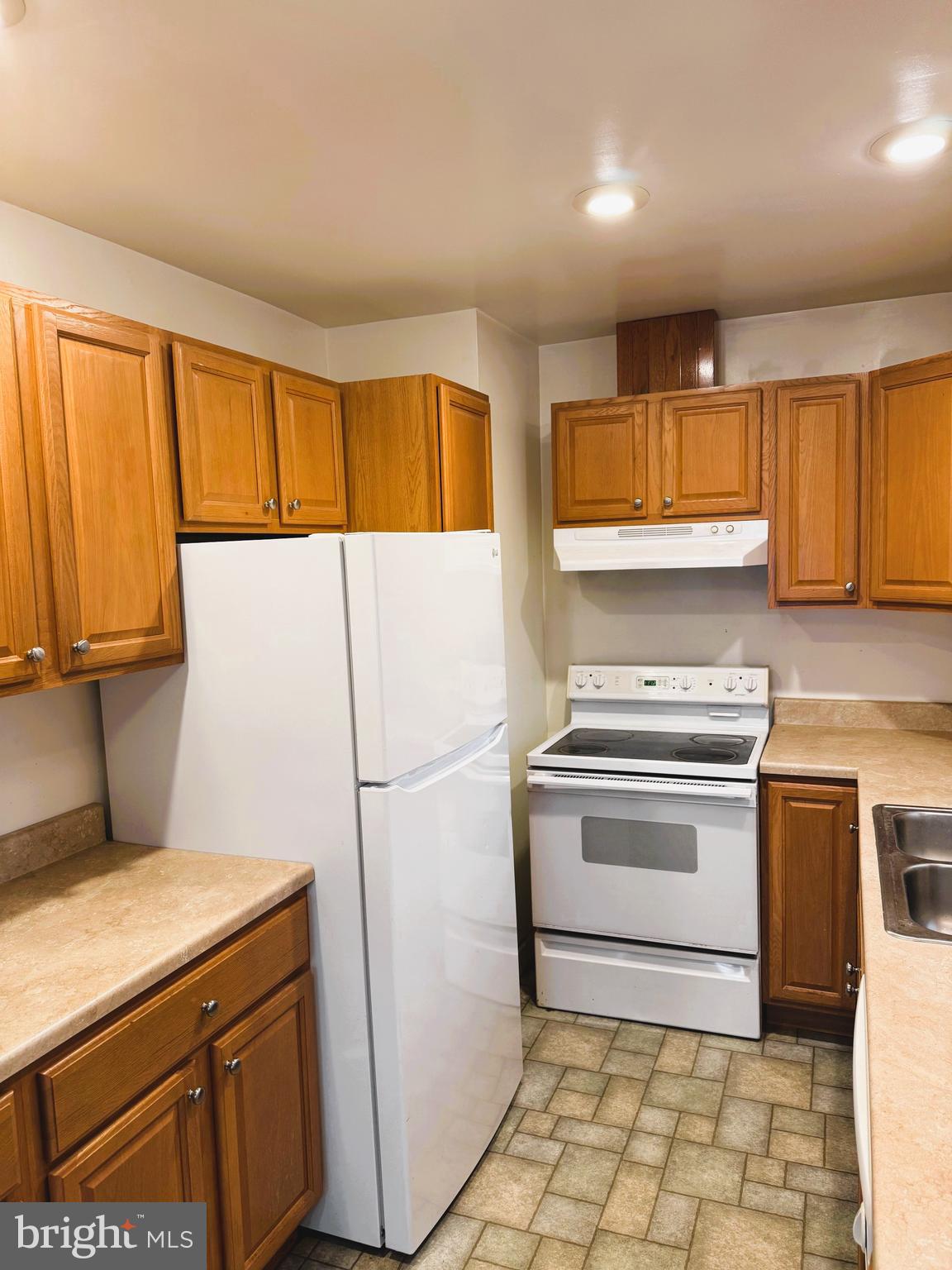 18 Cornell Avenue Bridgeton, NJ 08302 - Photo 7 of 20 a kitchen with a stove top oven sink and cabinets