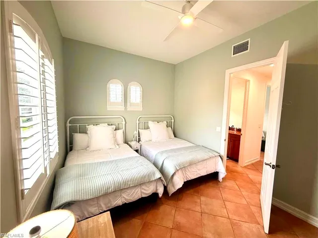 a bedroom with two beds and a window