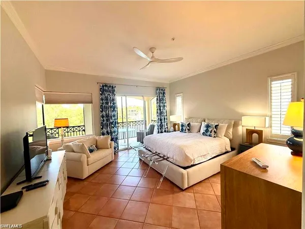 a bedroom with two beds and a large window