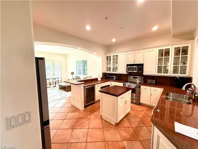 a kitchen with a sink a stove a microwave and cabinets