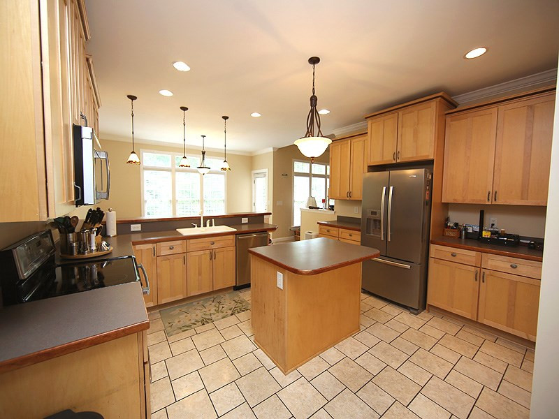 1313 Rhea Drive Garner, NC 27529 - Photo 7 of 25 Another view of the kitchen and the fabulous view out to the private backyard. Kitchen