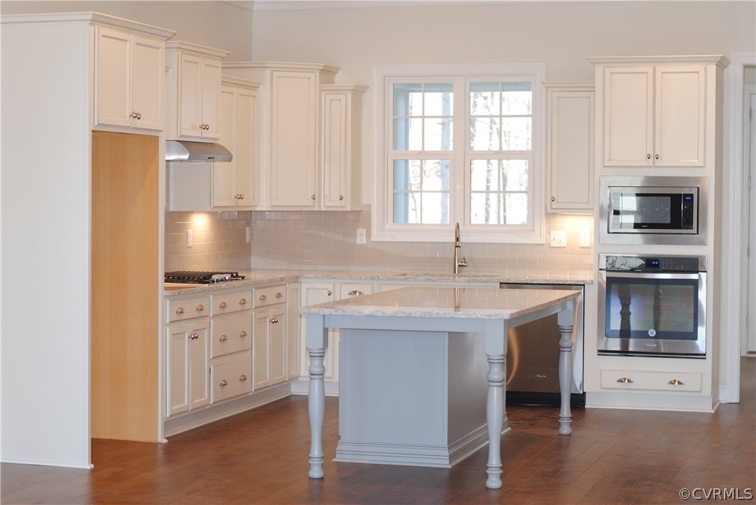1407 Winterfield Road Midlothian, VA 23113 - Photo 4 of 13 a kitchen with granite countertop a sink stove and cabinets