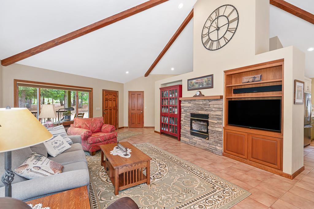 29082 Ridge View Road Foresthill, CA 95631 - Photo 11 of 78 a living room with furniture a flat screen tv and a fireplace