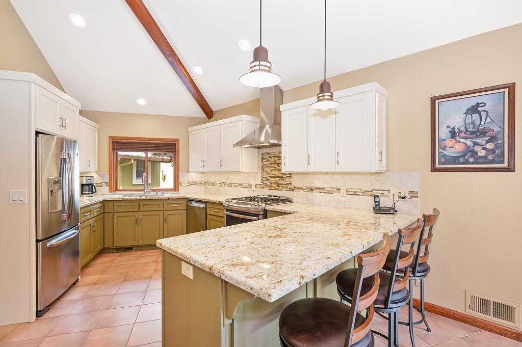 29082 Ridge View Road Foresthill, CA 95631 - Photo 14 of 78 a kitchen with a table chairs refrigerator and cabinets