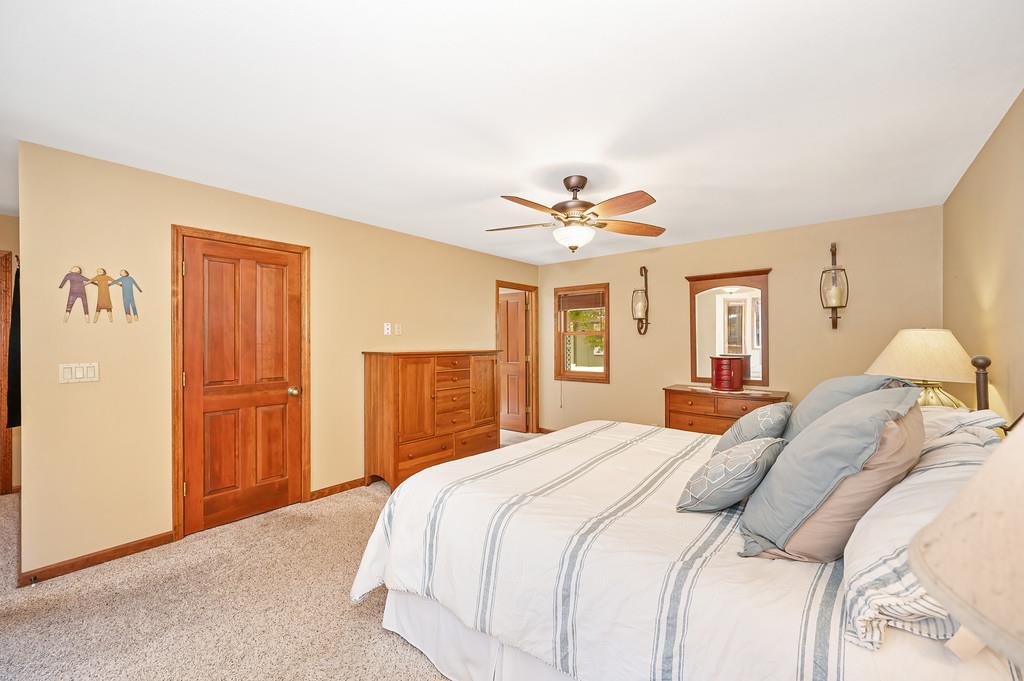 29082 Ridge View Road Foresthill, CA 95631 - Photo 20 of 78 a bedroom with a large bed and a chandelier