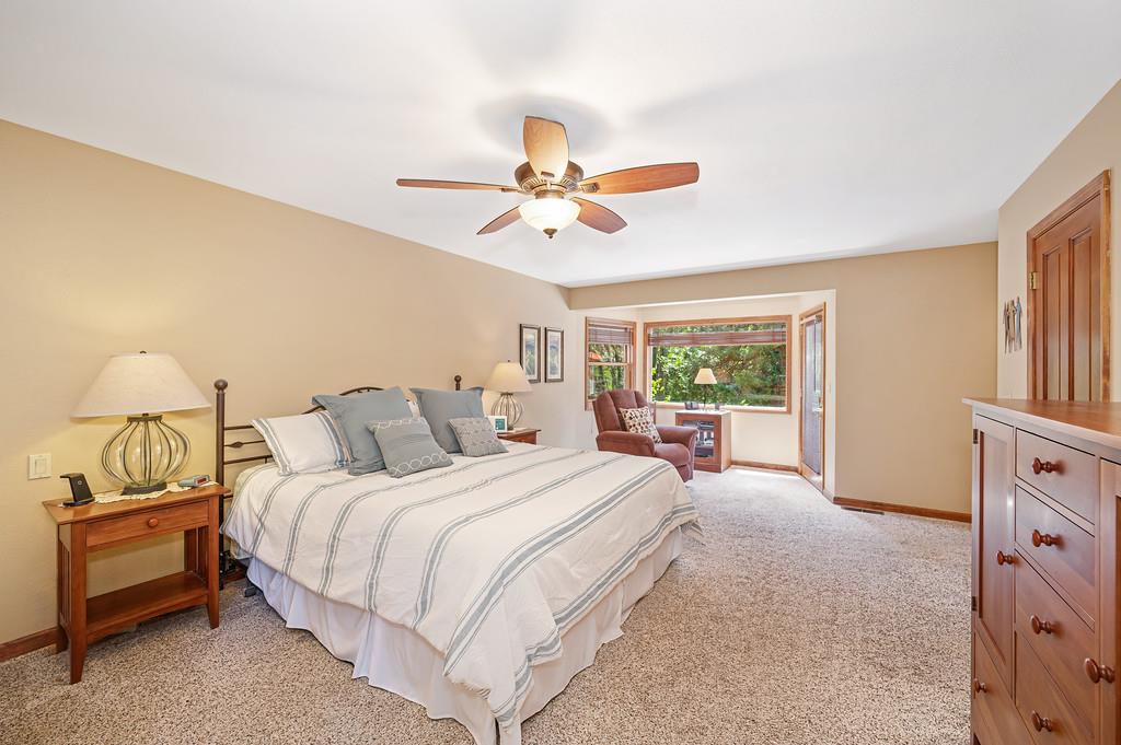 29082 Ridge View Road Foresthill, CA 95631 - Photo 22 of 78 a bedroom with a bed and a chandelier
