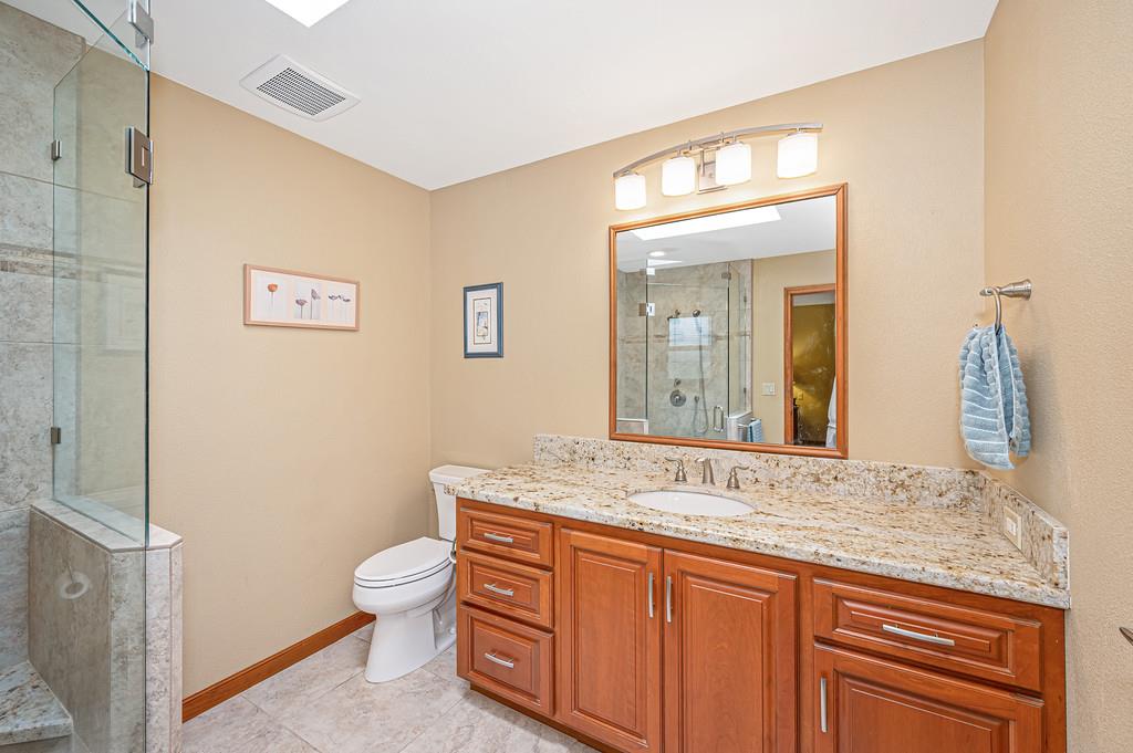 29082 Ridge View Road Foresthill, CA 95631 - Photo 23 of 78 a bathroom with a granite countertop toilet a sink and a mirror