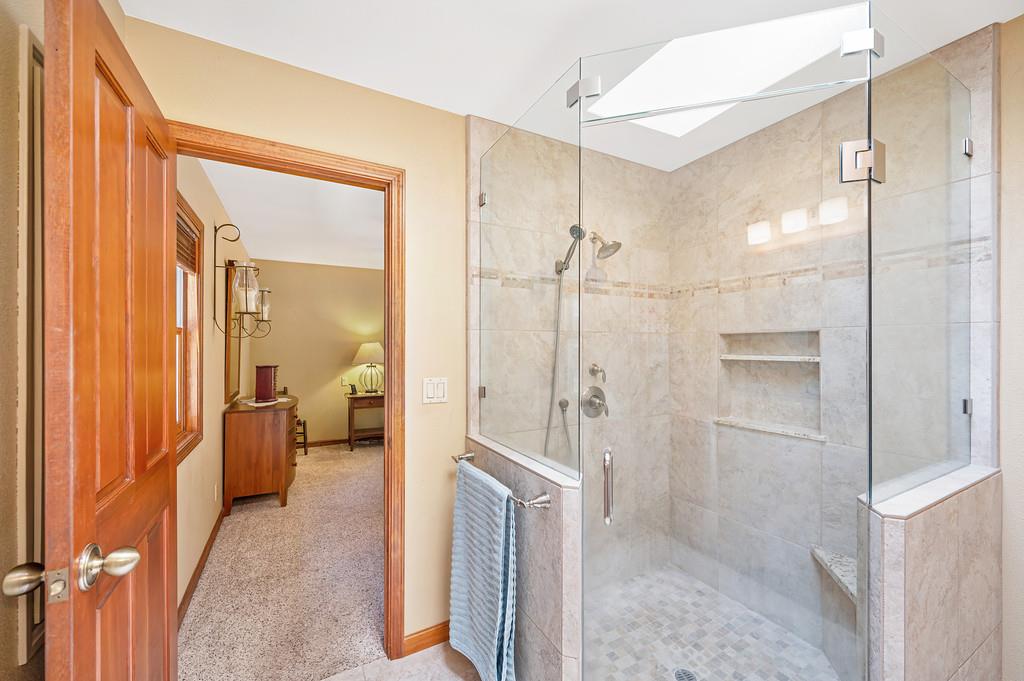 29082 Ridge View Road Foresthill, CA 95631 - Photo 24 of 78 a bathroom with a glass shower door and a glass door