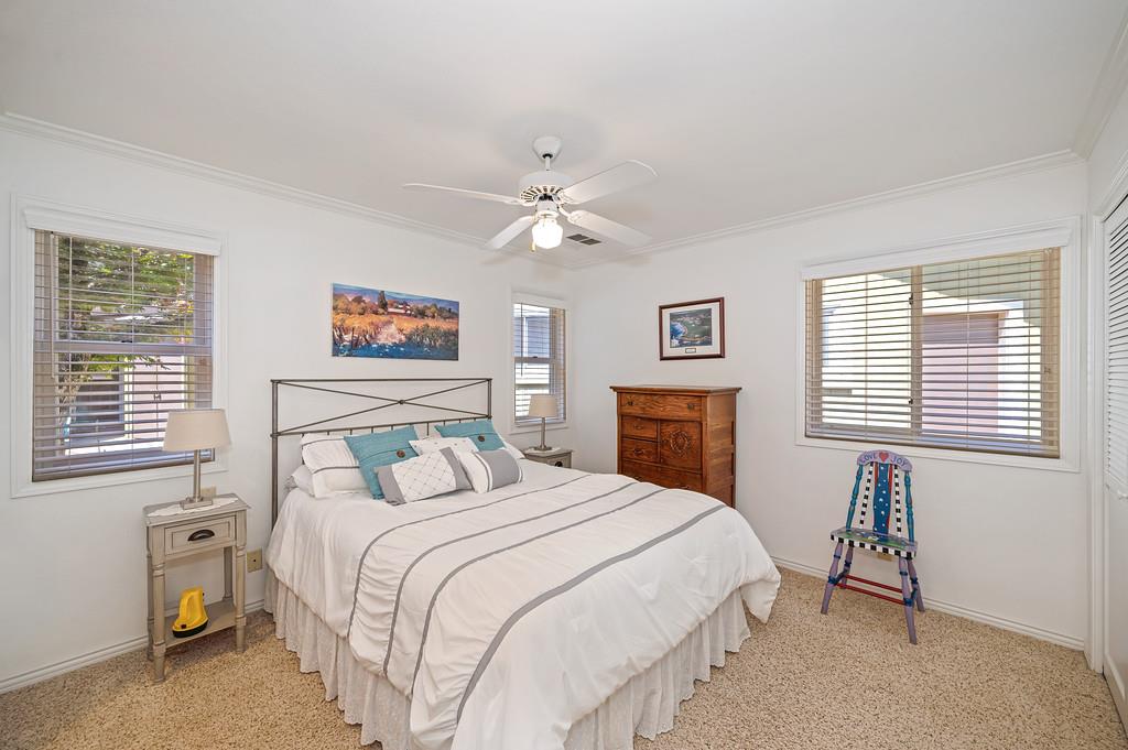 29082 Ridge View Road Foresthill, CA 95631 - Photo 39 of 78 a bedroom with a bed and a chandelier