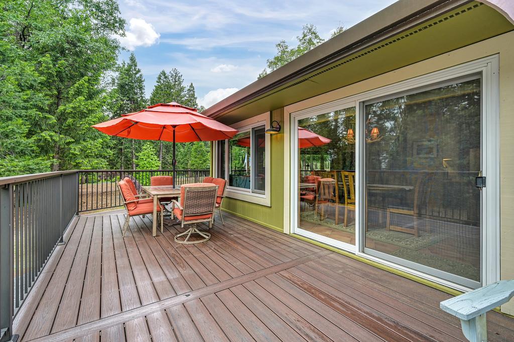 29082 Ridge View Road Foresthill, CA 95631 - Photo 56 of 78 a view of a patio with a table and chairs under an umbrella with wooden floor
