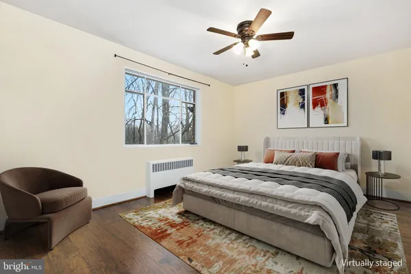 a bedroom with a bed couch and window
