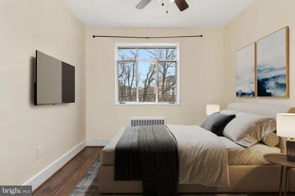 a bedroom with a large bed and a window