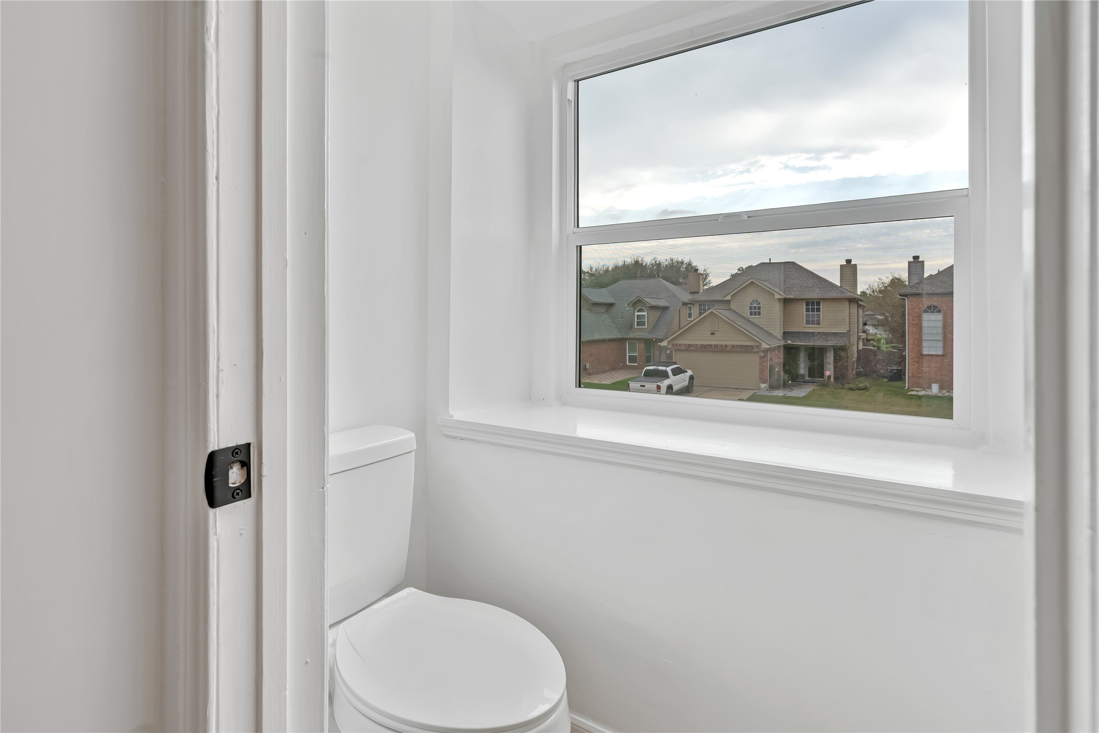 12426 North Rachlin Circle Houston, TX 77071 - Photo 16 of 31 a bathroom with a toilet and a painting on the wall
