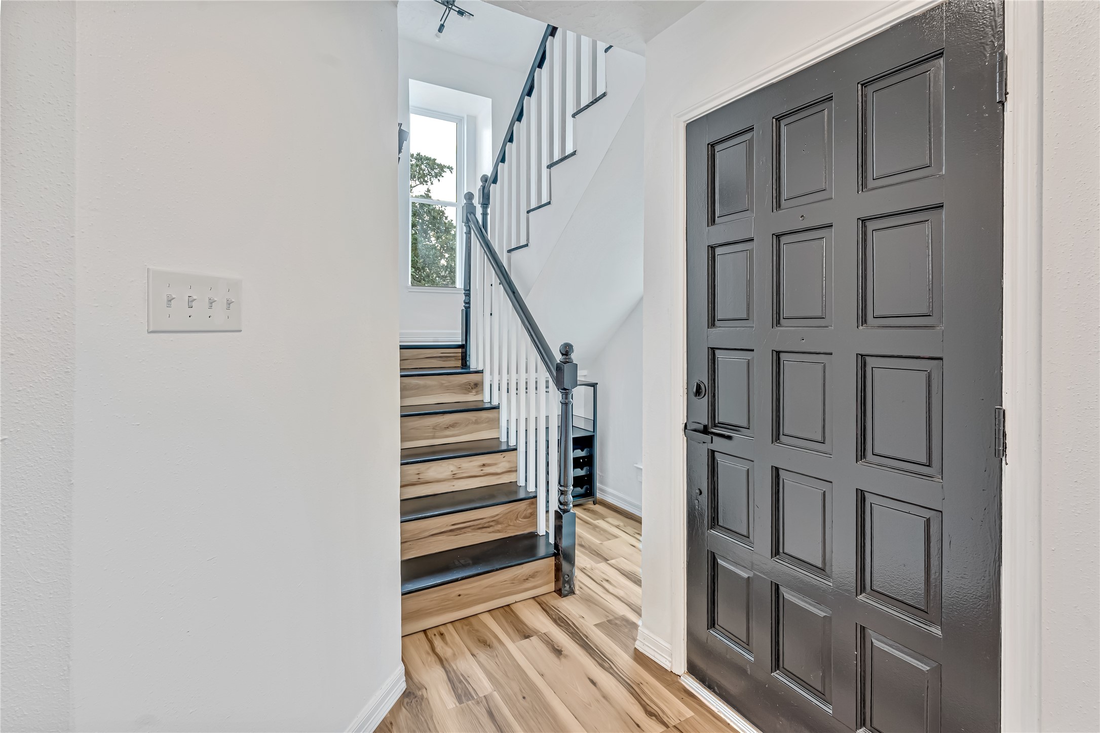 12426 North Rachlin Circle Houston, TX 77071 - Photo 26 of 31 a view of entryway with stairs and wooden floor