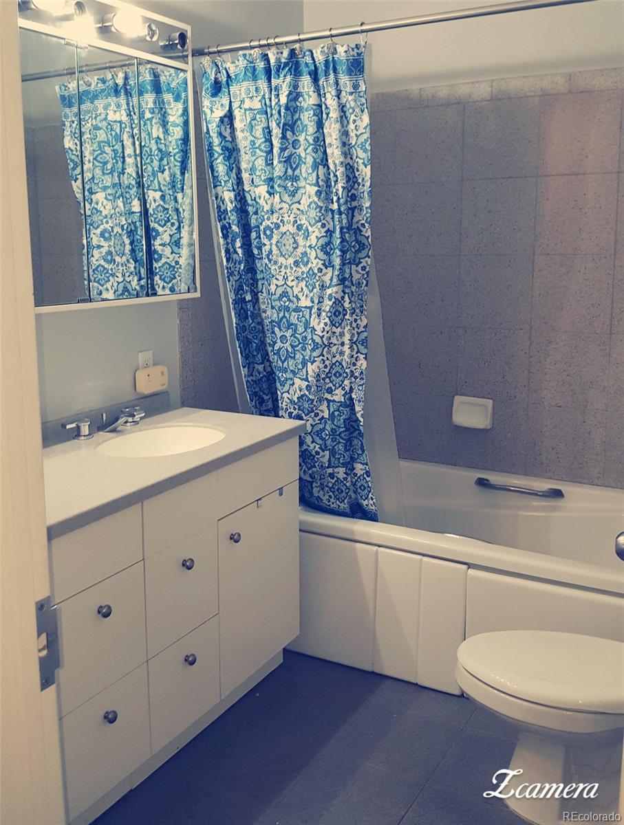 44 Lincoln Street Denver, CO 80203 - Photo 12 of 35 a bathroom with a granite countertop sink toilet and mirror