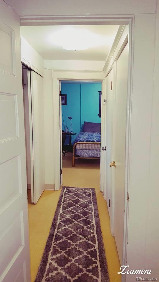 44 Lincoln Street Denver, CO 80203 - Photo 13 of 35 a hallway with a furniture and rug