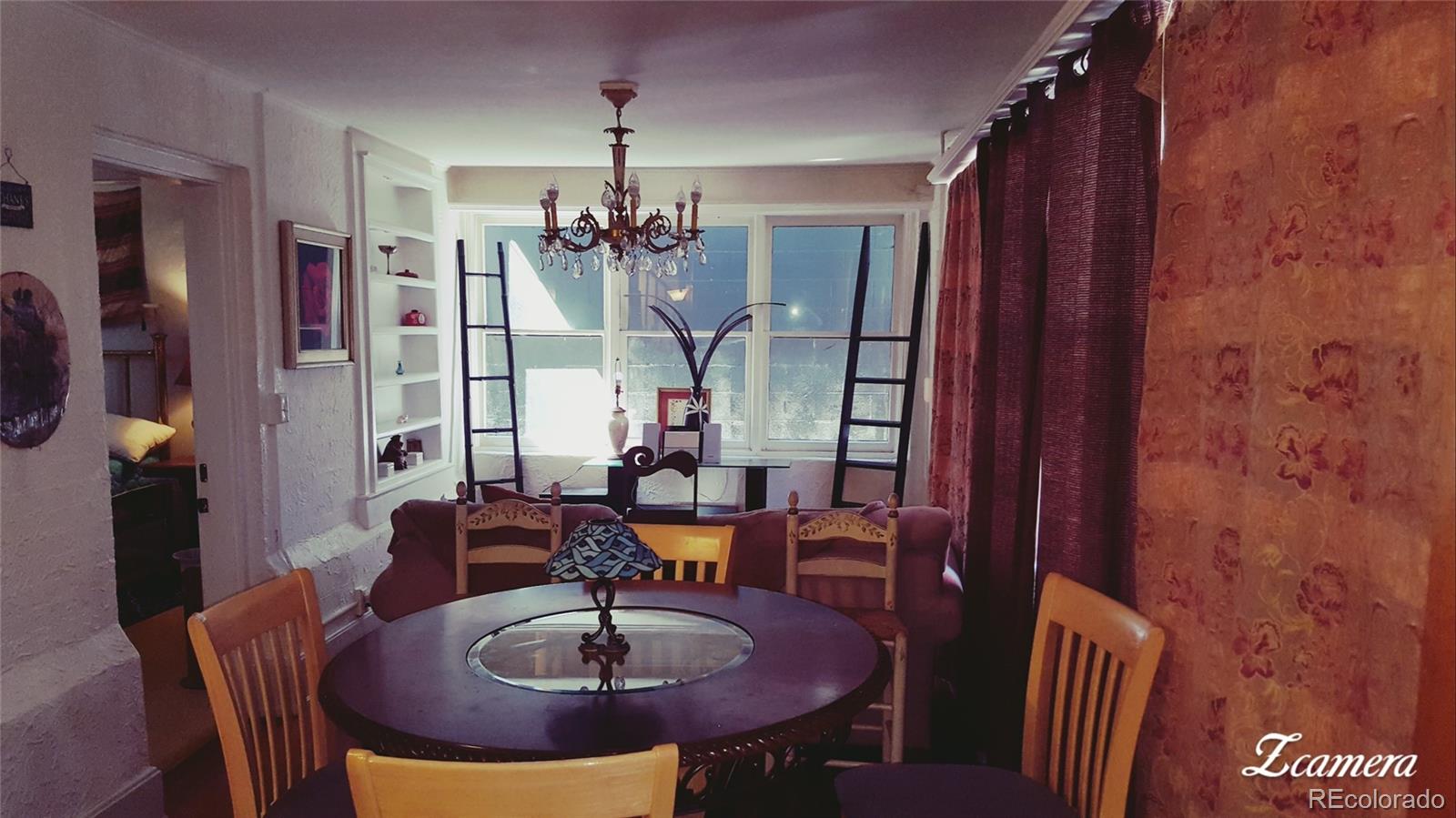 44 Lincoln Street Denver, CO 80203 - Photo 20 of 35 a view of a dining room with furniture and chandelier