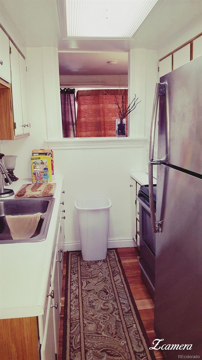 44 Lincoln Street Denver, CO 80203 - Photo 22 of 35 a bathroom with a sink a toilet and a mirror