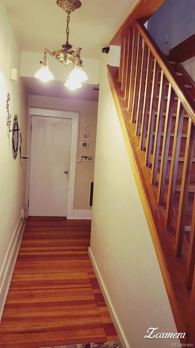 44 Lincoln Street Denver, CO 80203 - Photo 26 of 35 a view of a hallway with wooden floor and staircase