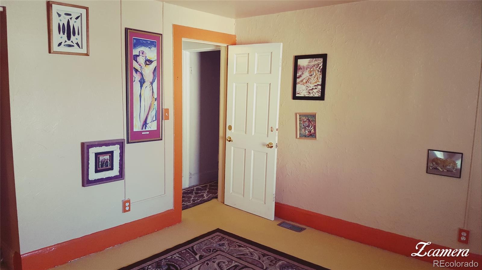 44 Lincoln Street Denver, CO 80203 - Photo 27 of 35 a view of a hallway with paintings on the wall
