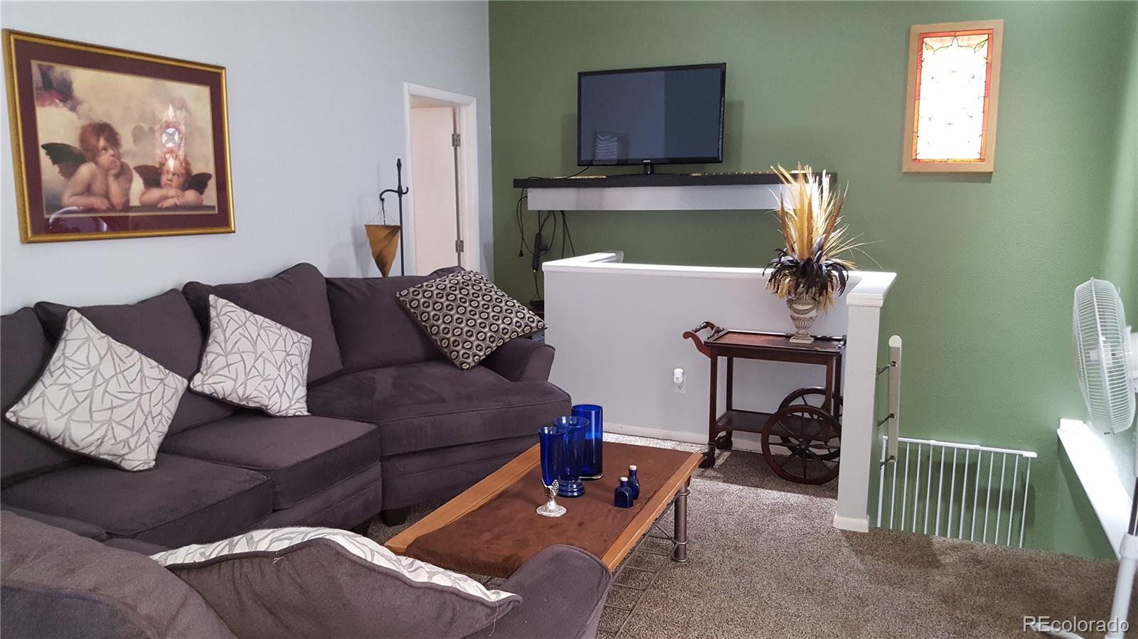 44 Lincoln Street Denver, CO 80203 - Photo 4 of 35 a living room with furniture and a painting on the wall