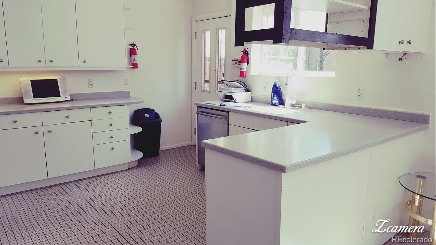 44 Lincoln Street Denver, CO 80203 - Photo 6 of 35 a kitchen with a cabinets and appliances