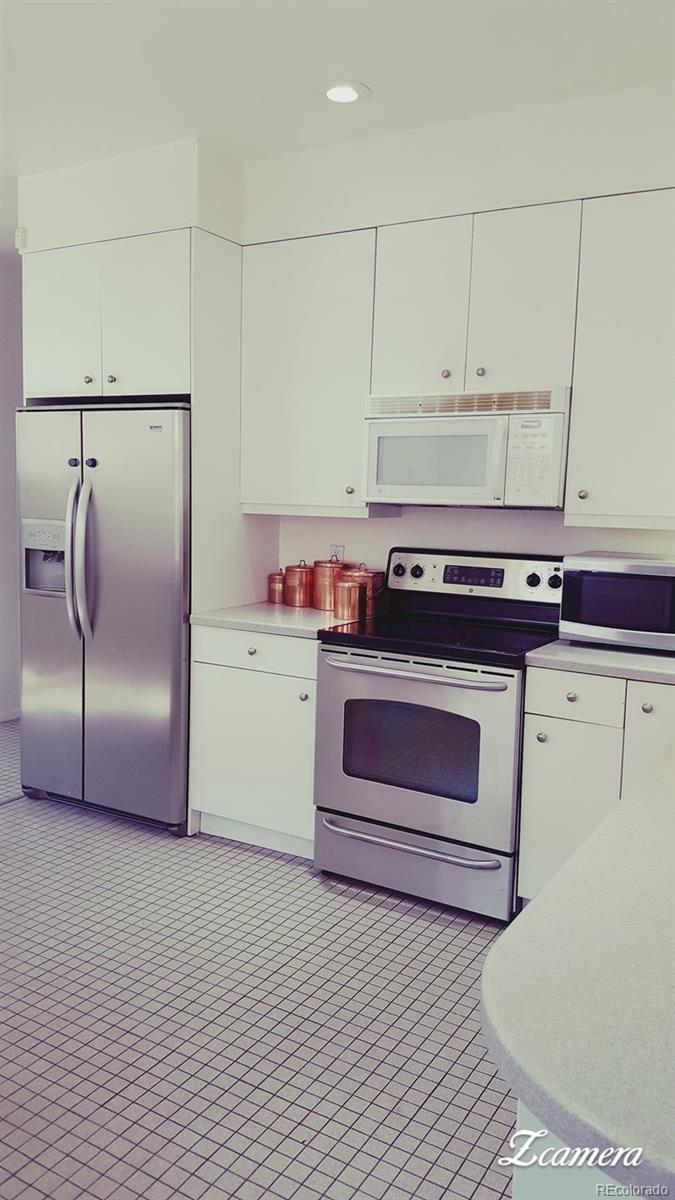 44 Lincoln Street Denver, CO 80203 - Photo 7 of 35 a kitchen with a stove and a refrigerator