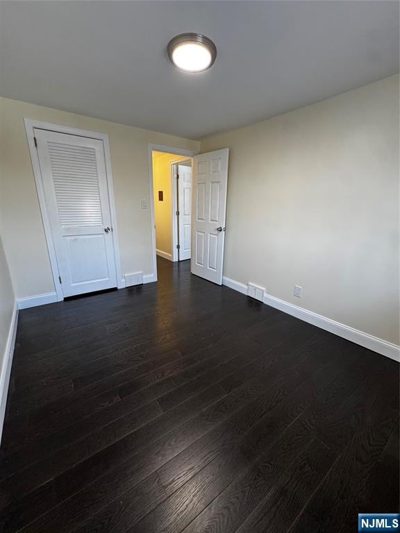 158 A Rutherford Place North Arlington, NJ 07031 - Photo 12 of 13 an empty room with wooden floor cabinet and windows