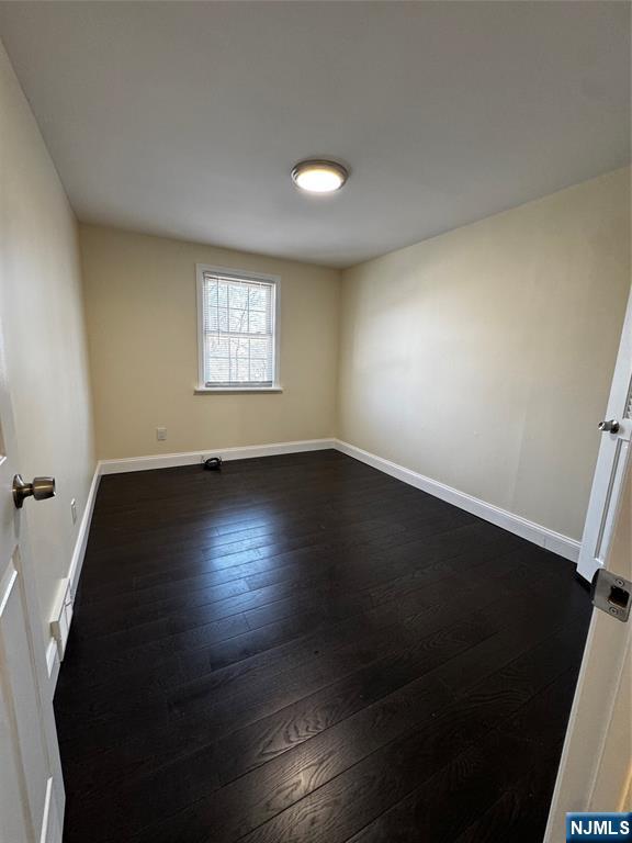 158 A Rutherford Place North Arlington, NJ 07031 - Photo 13 of 13 an empty room with wooden floor and windows